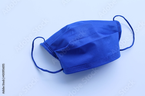 Face masks cloth blue wearing to anti virus protection corona COVID-19 isolated on white background closeup.