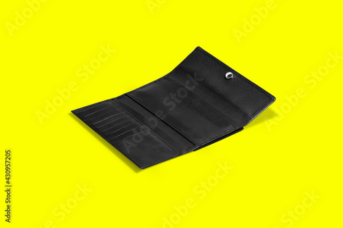 Fashionable leather women's wallet on a yellow background. added copy space for text.