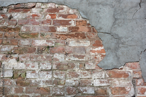 old brick wall with peeling plaster, abstract background, texture
