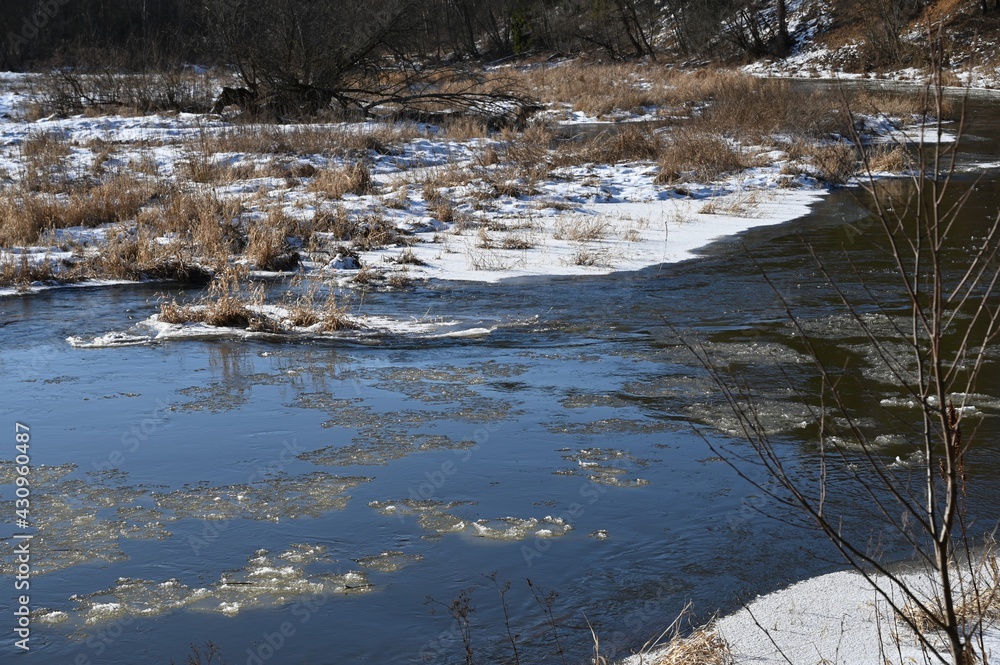 picturesque landscape of early spring on the river on a sunny day. Snow melting, nature awakening picturesque landscape of early spring on the river on a sunny day. Snow melting, nature awakening