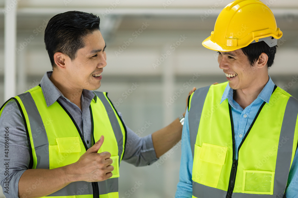 Senior and junior engineers talking together with intimated manner. Concept for good teamwork and unity of colleauges. Senior and junior engineers talking together with intimated manner. Concept for good teamwork and unity of colleauges.