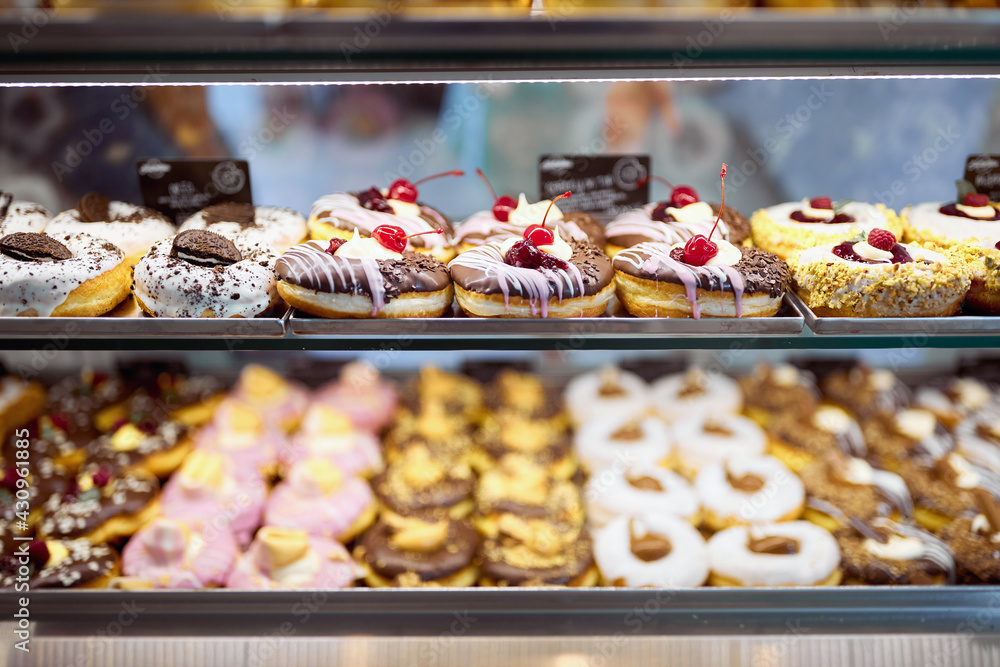 A show case full of delicious donuts in a candy shop. Pastry, dessert, sweet