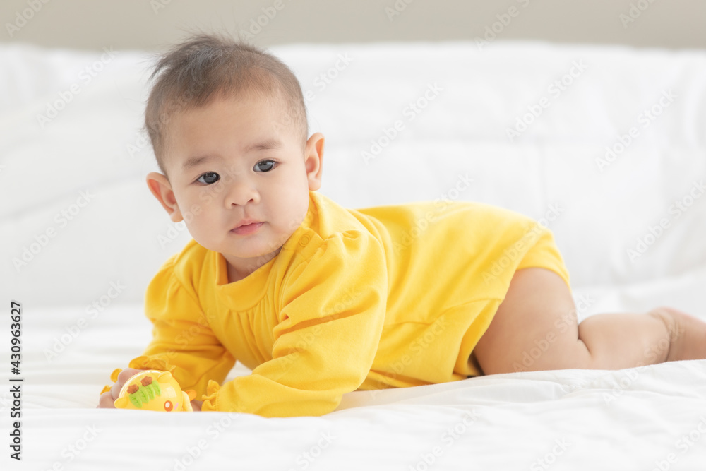 Portrait and focus to eye adorable baby child on white bed in bedroom look at camera with bright soft light in morning in background Portrait and focus to eye adorable baby child on white bed in bedroom look at camera with bright soft light in morning in background