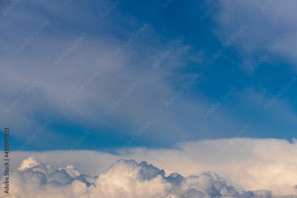 The blue sky with clouds as the blue backdrop in the air The nature of the blue sky with clouds in the morning, the blue sky with white, soft clouds