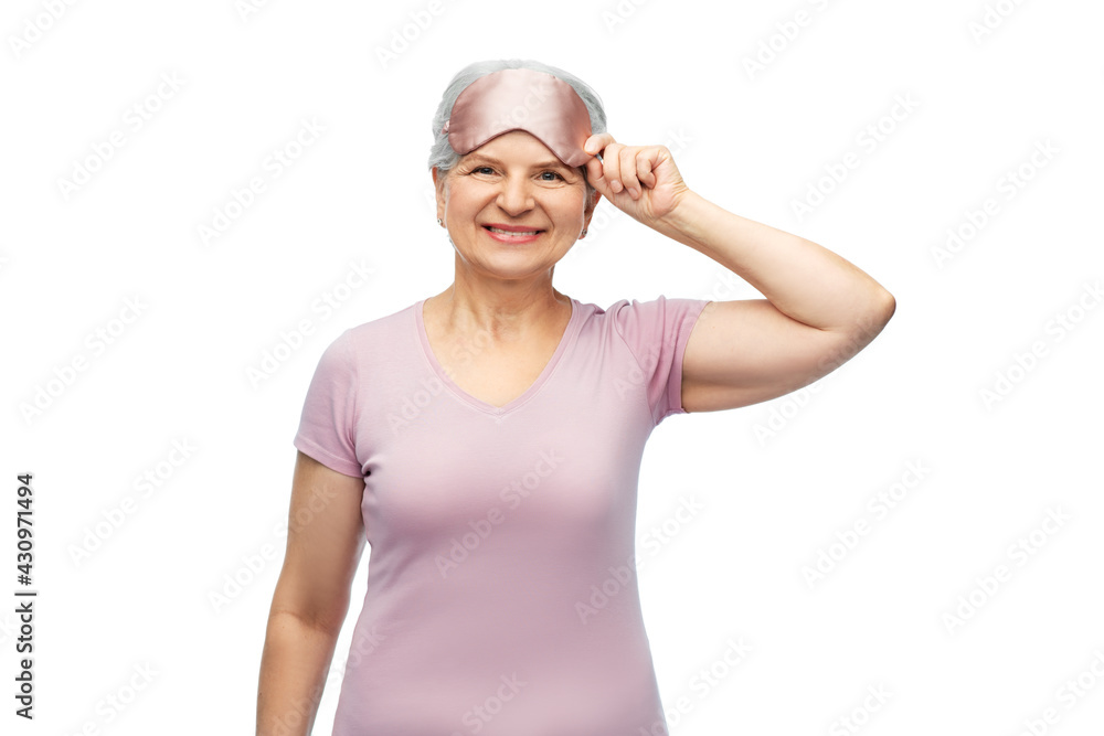 old people concept - portrait of smiling senior woman in pajamas and eye sleeping mask over white background