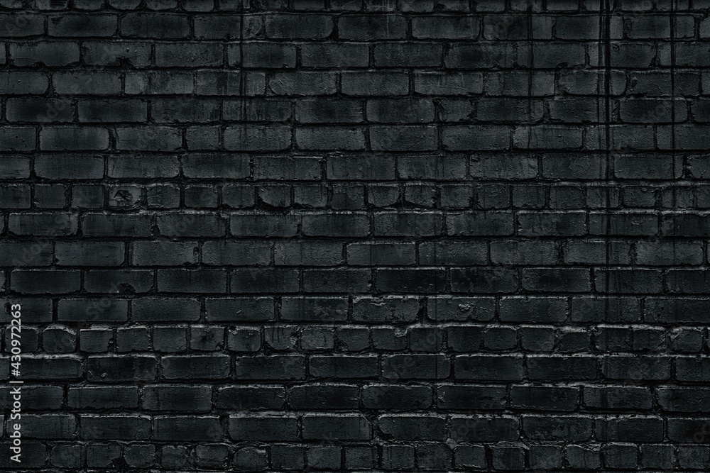 Black dirty brick wall texture. Old rough brickwork backdrop. Gloomy dark grey block masonry grunge background