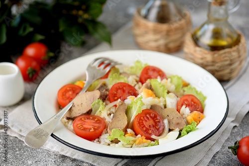 Cod liver salad with boiled eggs, cherry tomatoes, onions, lettuce and rice.