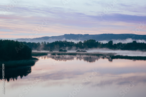 Beautiful morning landscape with fog over the river