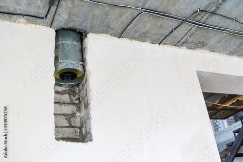 Fototapeta Naklejka Na Ścianę i Meble -  Fragment of the ventilation duct. Chimney installation in a large house. Copy space