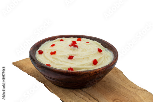 badam, kesar , pista shrikhand or amrakhand in a wooden bowl with food styling for food product packaging or social media  photo