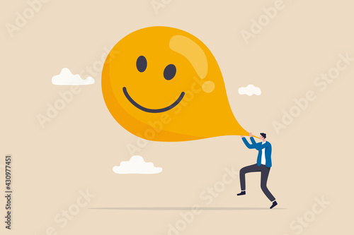 Maximize happiness, let go anxiety and think positive concept, man blow big smile yellow balloon.