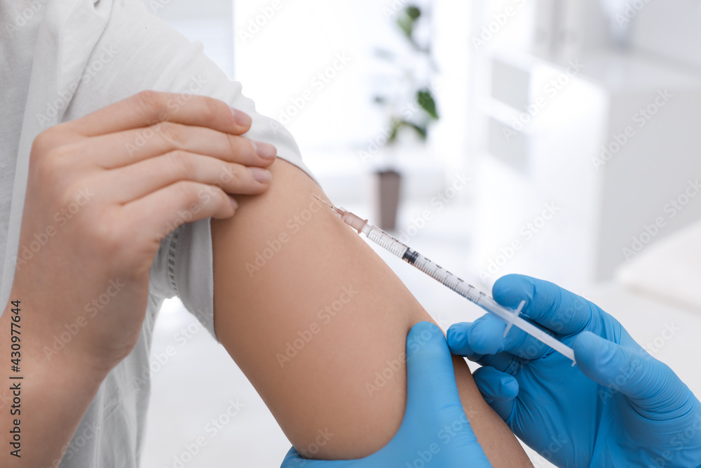 Doctor giving injection to woman in hospital, closeup. Immunization concept Doctor giving injection to woman in hospital, closeup. Immunization concept