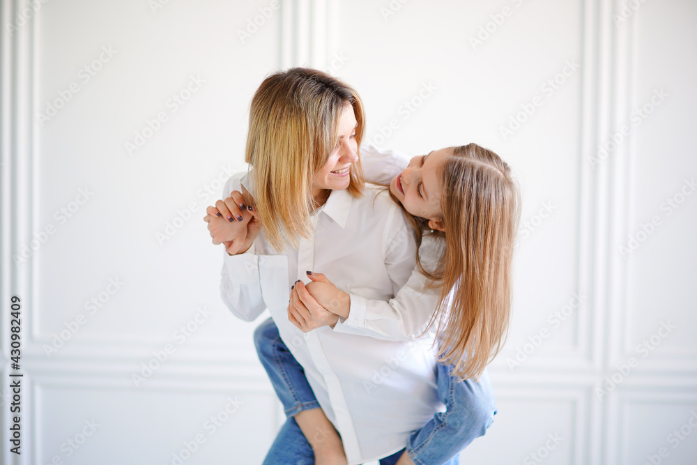 Portrait of little girl loving mother and holding her Portrait of little girl loving mother and holding her