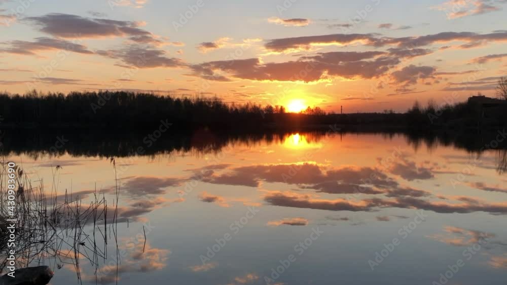 Dramatic sky with clouds reflect in still water surface of forest lake at sunset. Dramatic sky with clouds reflect in still water surface of forest lake at sunset.