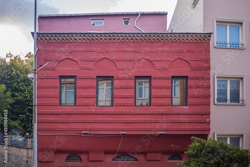 Facades of ancient buildings in Istanbul city on the background of blue sky on a sunny summer day, public places photo