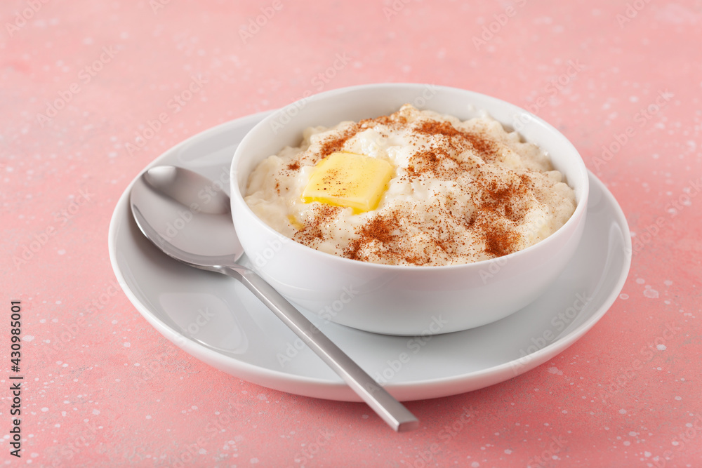 rice pudding with butter cinnamon. french riz au lait, norwegian risgrot, traditional breakfast dessert rice pudding with butter cinnamon. french riz au lait, norwegian risgrot, traditional breakfast dessert