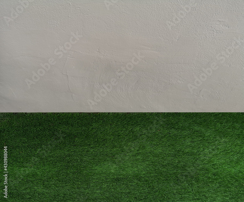 Green lawn grass floor nature park and grey cement wall background