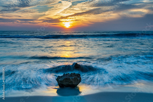 Smoky sky sunset, flowing water over rocks, at Trigg Beach, Perth West Australia photo