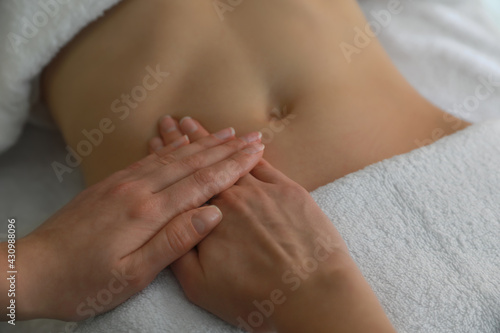 Woman receiving professional belly massage, closeup view © New Africa