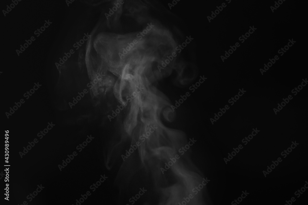 White steam in air against black background White steam in air against black background