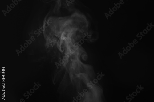 White steam in air against black background