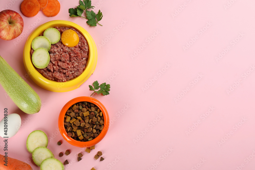 Pet food and natural ingredients on pink background, flat lay. Space for text Pet food and natural ingredients on pink background, flat lay. Space for text