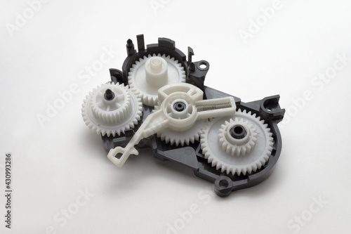 inkjet printer paper feeder mechanical drive. four external spur gear wheels, with different gear ratios. reducer of plastic cogwheels. with clipping path
