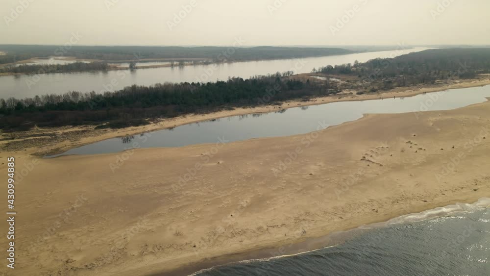Ascending aerial shot of beautiful landscape with Vistula River Mouth surrounded by Nature Reserve with Lake and Sand Bank. Ascending aerial shot of beautiful landscape with Vistula River Mouth surrounded by Nature Reserve with Lake and Sand Bank.