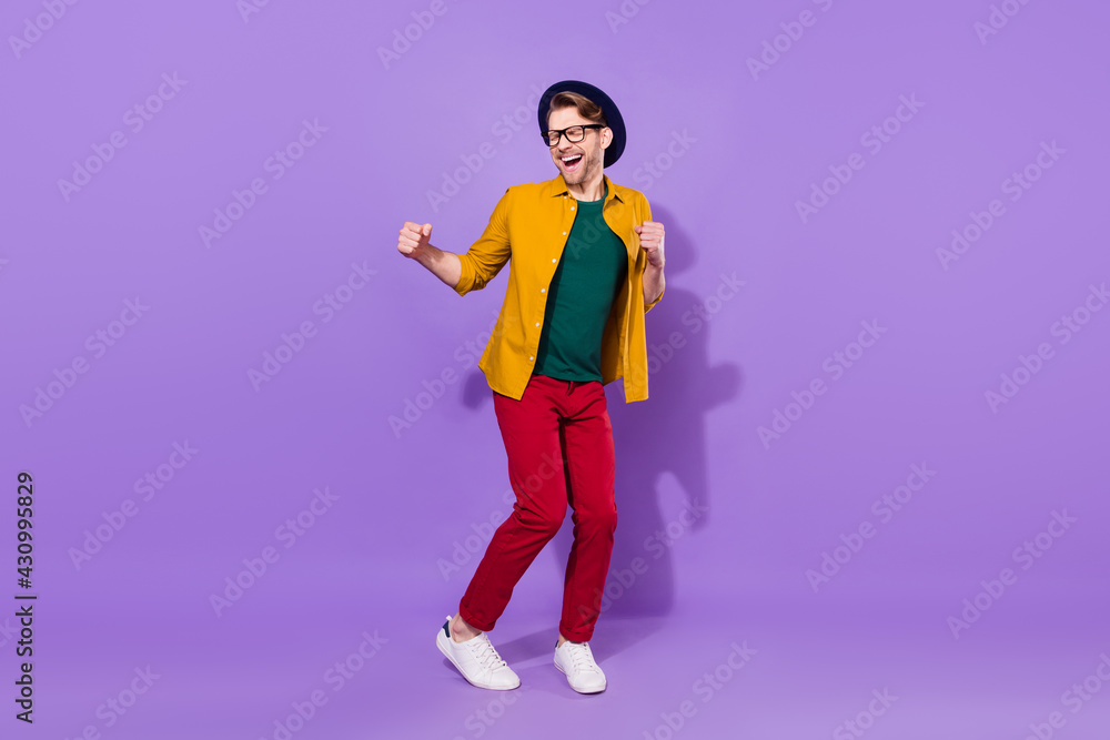Fototapeta premium Full length photo of cheerful positive young man dance winner good mood isolated on violet color background