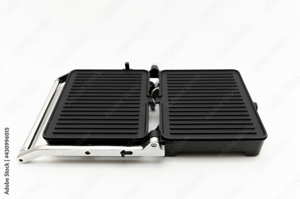 electric grill on a white background. mode wheel and electric grill control panel. household appliances.folding grill. modern electric grill