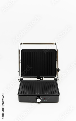 large electric grill on a white background. household appliances for picnic and family celebrations. the grill is folding and modern. multifunctional grill