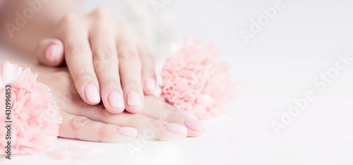 Banner manicure beautiful stylish trendy woman pink nails with flower on white background  top view