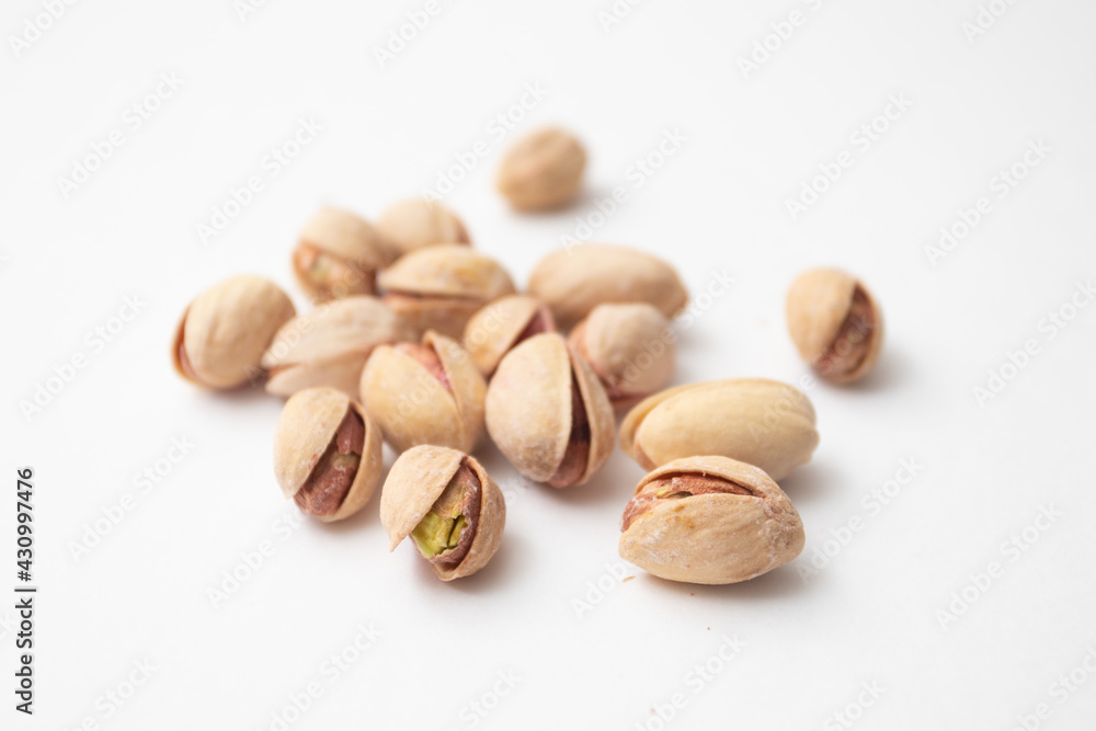 Pile of pistachios on a white background. Pistachio nuts Pile of pistachios on a white background. Pistachio nuts