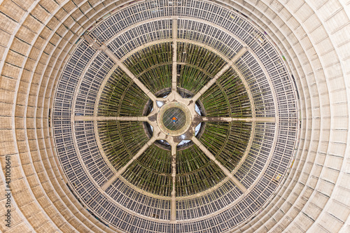 Aerial view of a man laying down on the floor of an abandoned Power plant reactor funnel in Charleroi, Belgium.