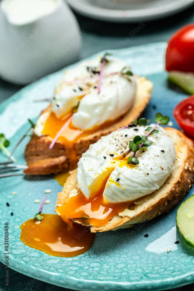 Sandwich with Poached Egg. Bread Toast sliced egg and fresh vegetable salad with cup of coffee for healthy breakfast or snack Sandwich with Poached Egg. Bread Toast sliced egg and fresh vegetable salad with cup of coffee for healthy breakfast or snack