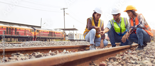 Rail logistics engineers are discussing the train tracks.