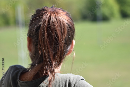 Woman searching the horizon with purple hair.