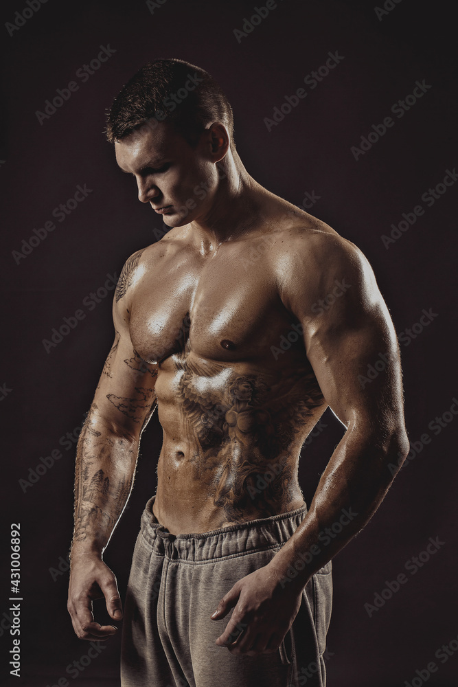 Studio portrait of a shirtless athletic tattooed male Studio portrait of a shirtless athletic tattooed male