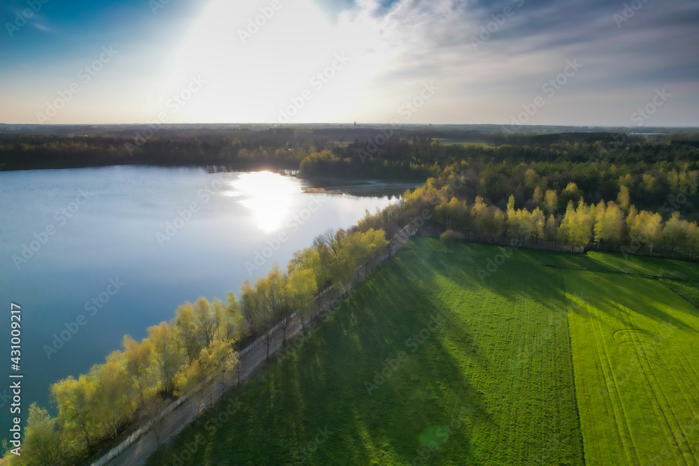 Stunning aerial drone landscape image of sunset or sunrise in spring over Europese countryside. High quality photo