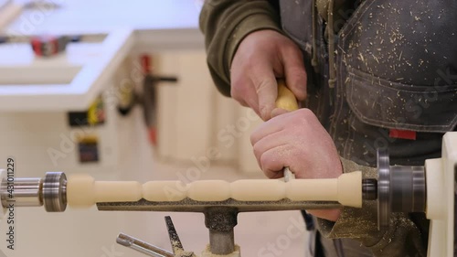 Close up. Carpenter at workshop polishes wooden board with a electric orbital sander. Woodwork and furniture making concept. photo