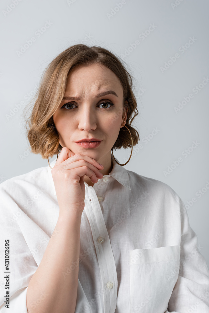 pensive overweight woman in white shirt isolated on grey pensive overweight woman in white shirt isolated on grey