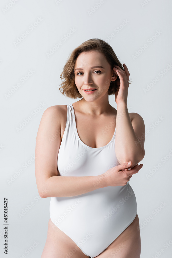 happy overweight woman in swimwear posing isolated on white