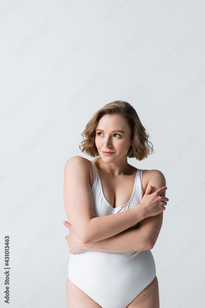 overweight and shy woman with crossed arms posing isolated on white overweight and shy woman with crossed arms posing isolated on white