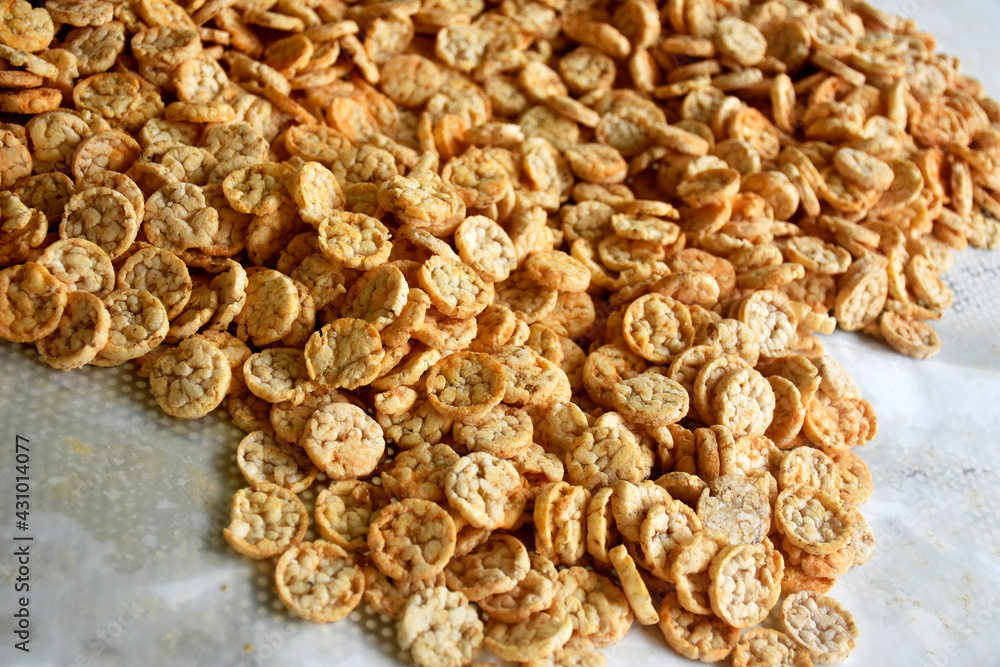 Popped Japanese brown rice is ground into powder, then made into a round disk, then crispy until golden brown and then dried. Popped Japanese brown rice is ground into powder, then made into a round disk, then crispy until golden brown and then dried.