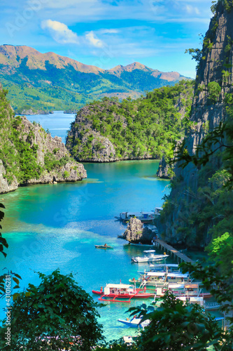 Landscape of hidden crystal clear turquoise water lake in the Philippines and blue ocean in summer
