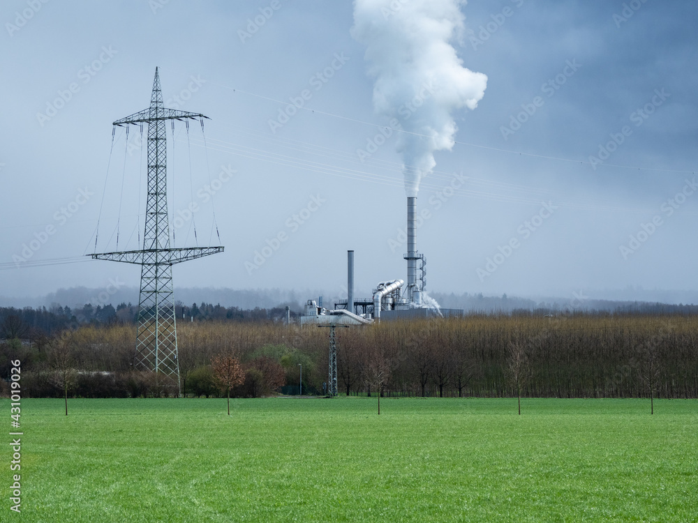 smoking chimney of a factory against sky in Germany smoking chimney of a factory against sky in Germany