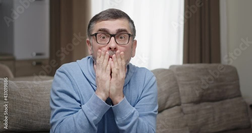 Mature man looking at camera in disbelief