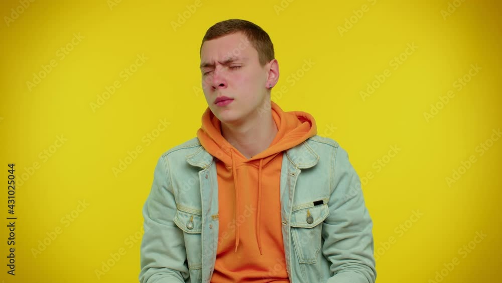 Tired handsome stylish teen boy in denim jacket yawning, sleepy inattentive feeling somnolent lazy bored gaping suffering from lack of sleep. Young adult man isolated on yellow studio wall background Tired handsome stylish teen boy in denim jacket yawning, sleepy inattentive feeling somnolent lazy bored gaping suffering from lack of sleep. Young adult man isolated on yellow studio wall background