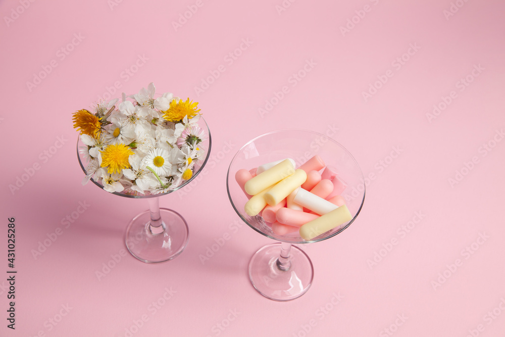 cosmetic background with cosmetic sticks and flovers cosmetic background with cosmetic sticks and flovers