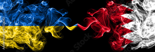 Ukraine  Ukrainian vs Bahrain  Bahraini smoky mystic flags placed side by side. Thick colored silky abstract smokes flags.